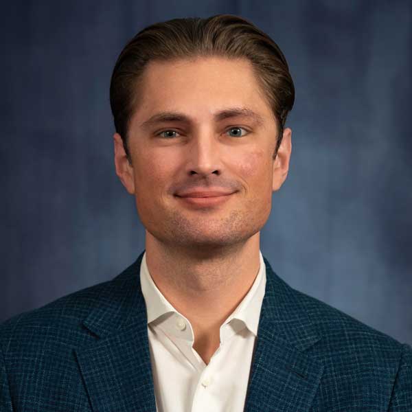 Smiling man in a blue suit.